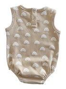 Tan baby romper with white rainbow prints and snap closure at the back.