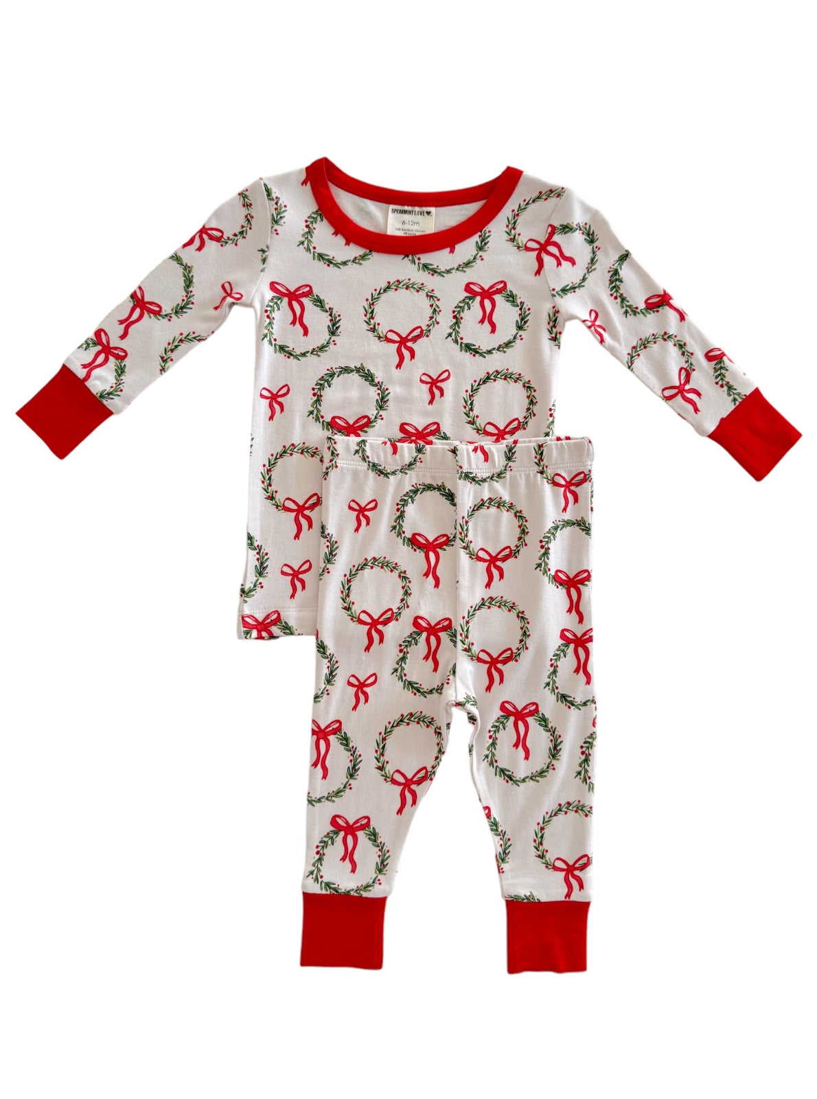 White pajama set featuring red and green wreaths with bows, perfect for festive occasions.