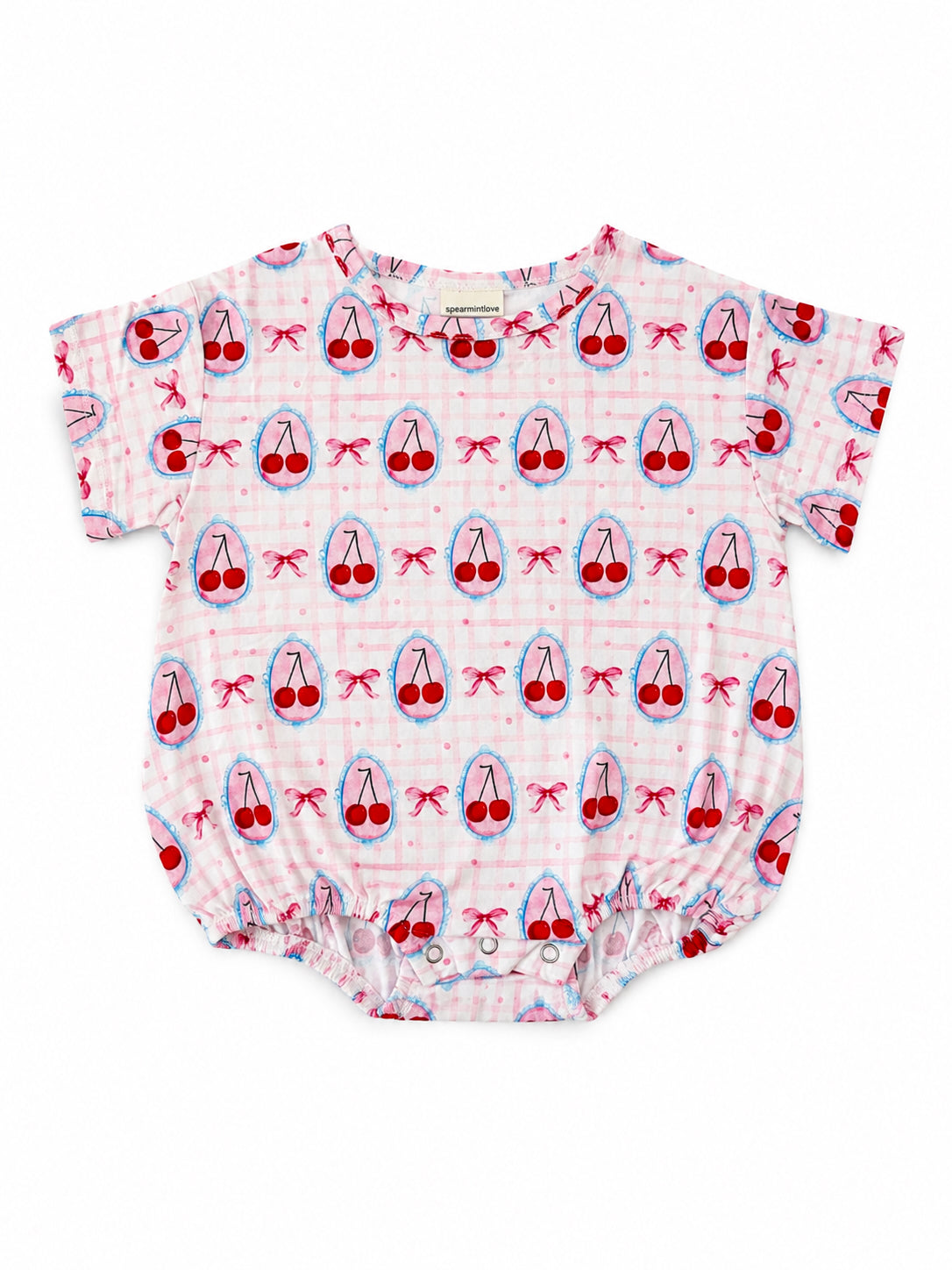 Pink baby onesie with a cherry and bow print, featuring short sleeves and a snap closure at the bottom.