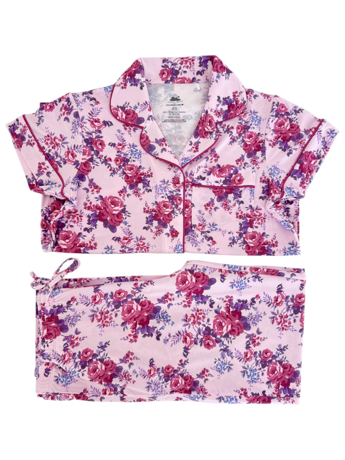 Floral pajama set featuring a short-sleeve top and matching pants in pink, purple, and white colors.