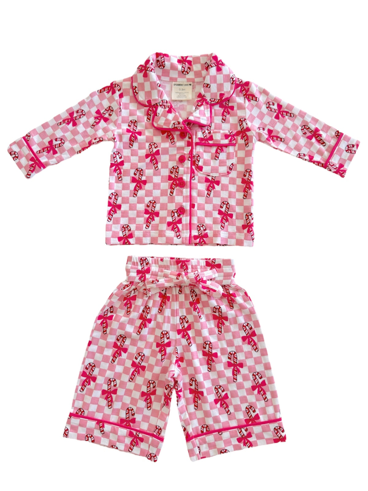 Pink checkered pajama set featuring candy cane pattern, includes long-sleeve top and matching shorts.