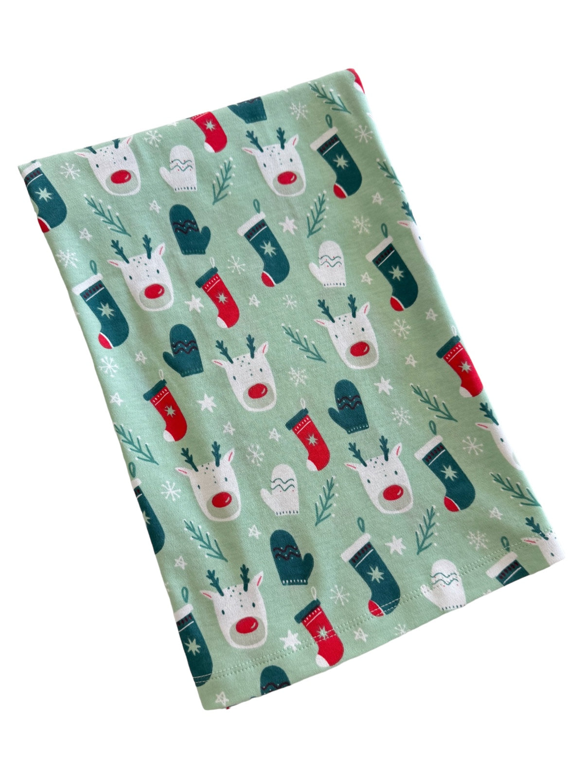 Green fabric featuring festive reindeer, mittens, and stockings in a whimsical holiday pattern.