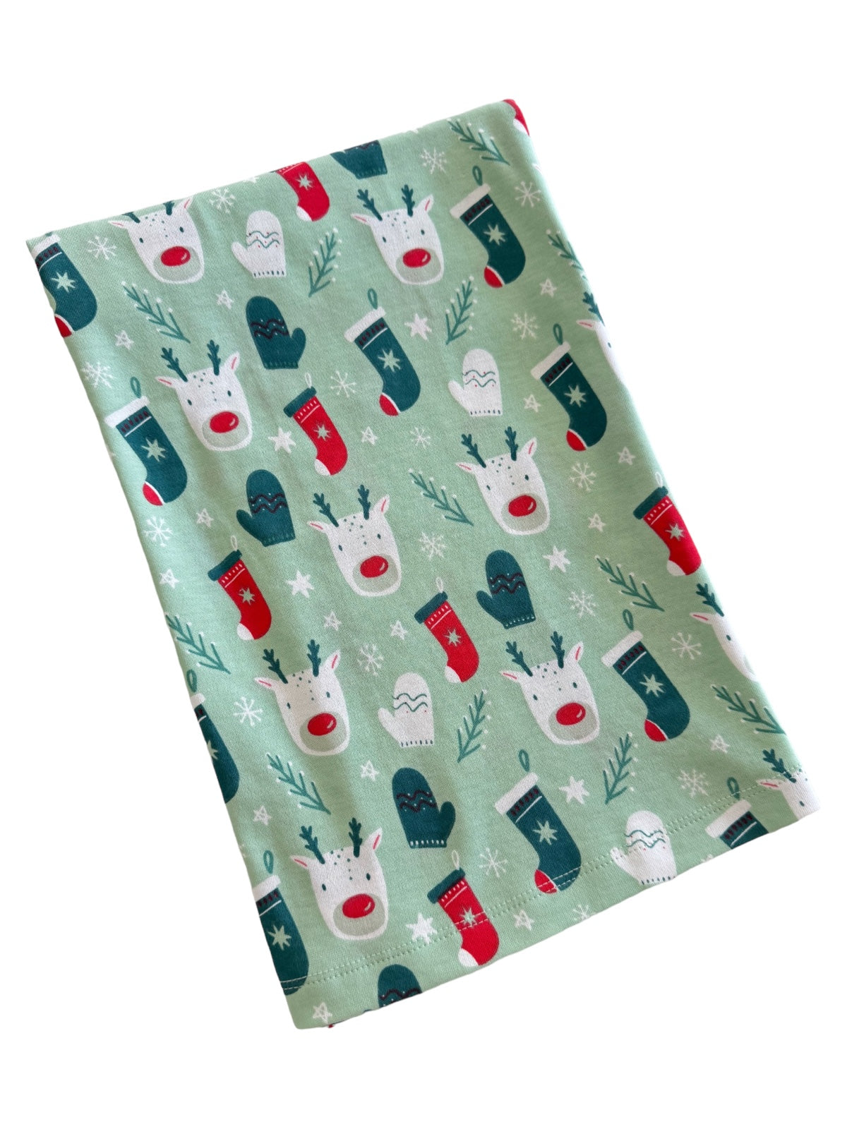 Green fabric featuring festive reindeer, mittens, and stockings in a whimsical holiday pattern.