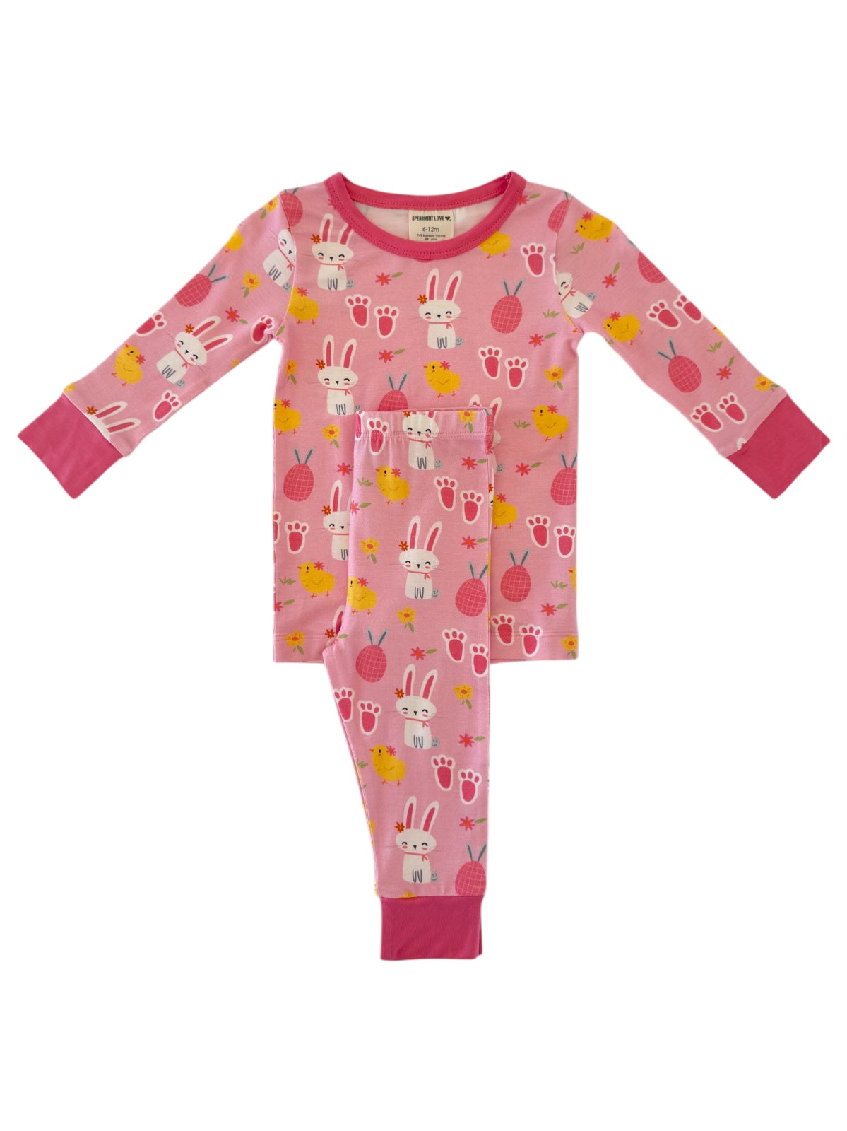 Pink children’s pajamas featuring bunnies, chicks, and strawberries in a playful pattern. Suitable for sleepwear.