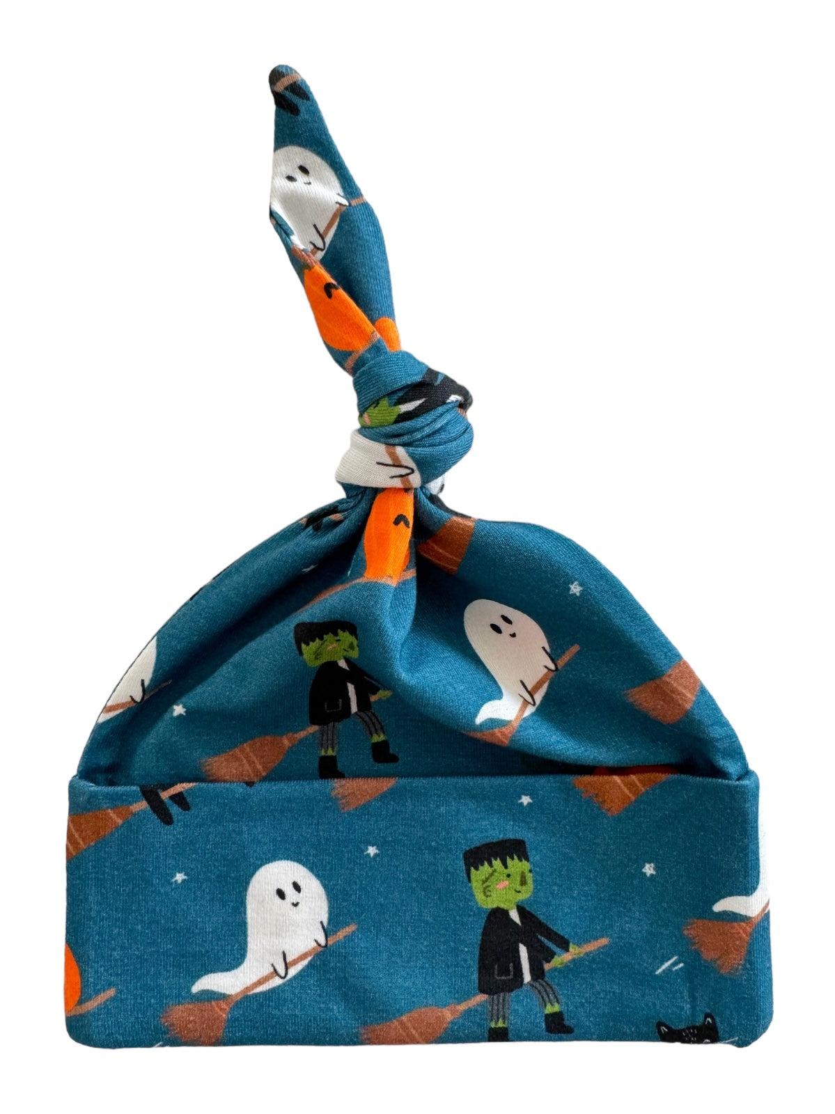 Blue hat with ghosts, Frankensteins, and brooms, featuring a knotted top for a playful Halloween theme.