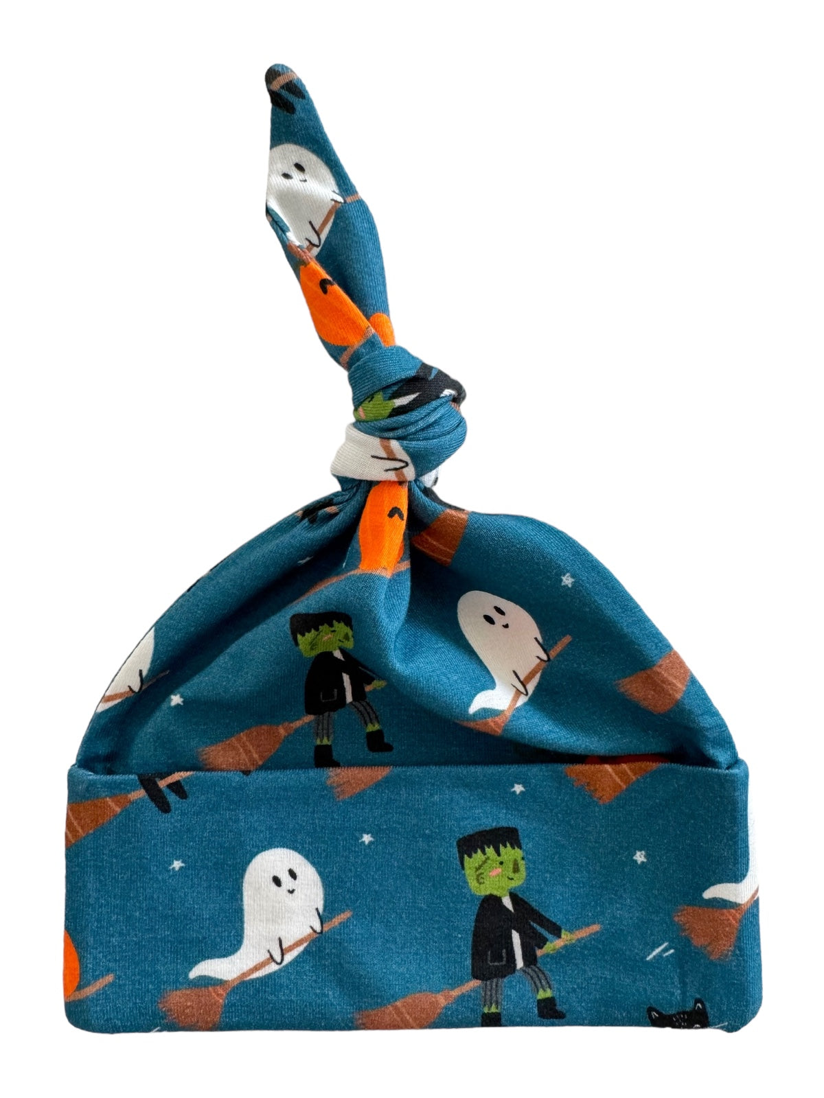 Blue hat with ghosts, Frankensteins, and brooms, featuring a knotted top for a playful Halloween theme.