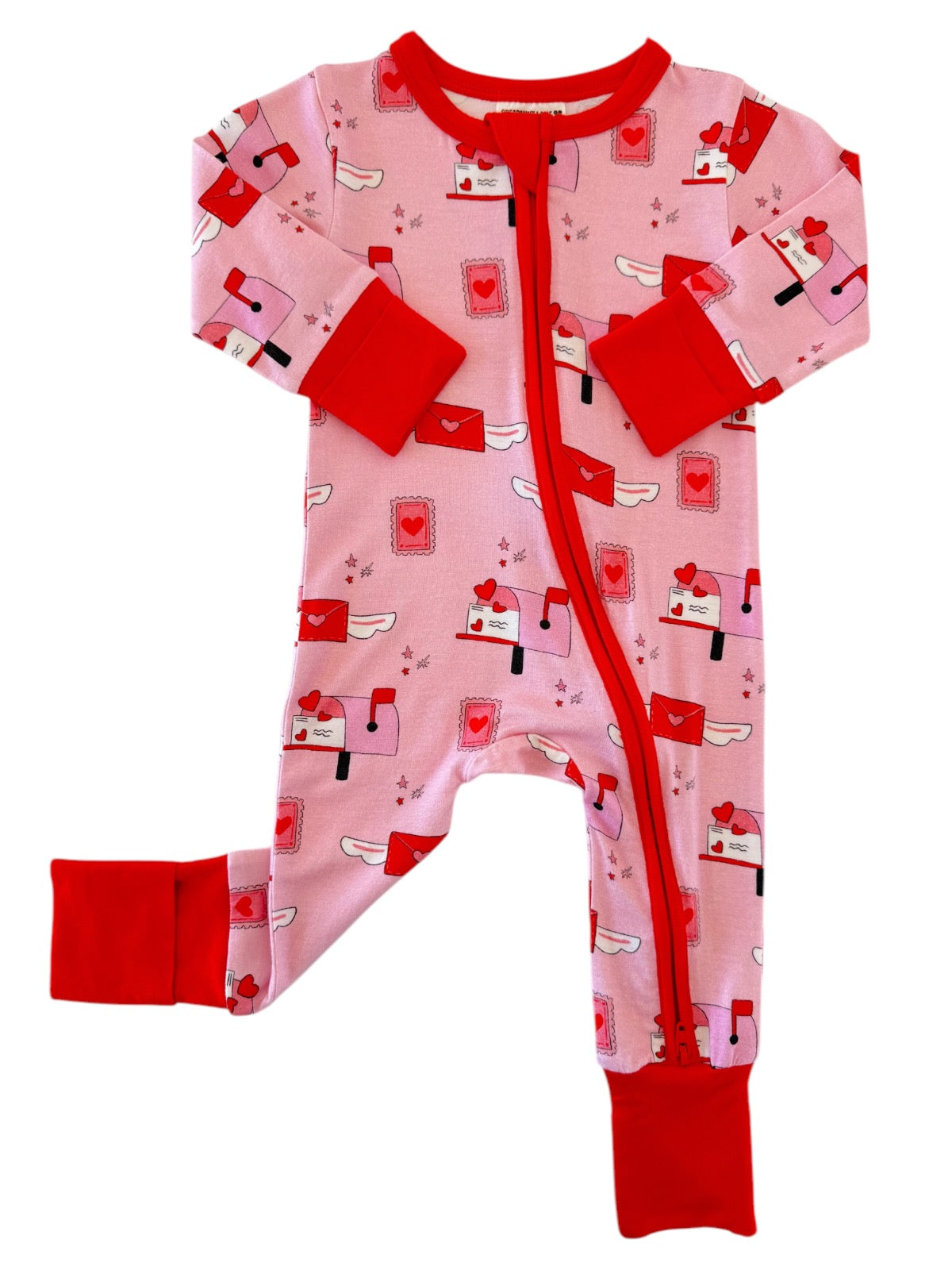 Pink kids' pajamas featuring mailboxes and heart designs with red cuffs and a front zipper.