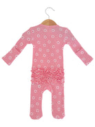 Pink baby romper with flower pattern and ruffle details, hanging on a wooden hanger against a white background.