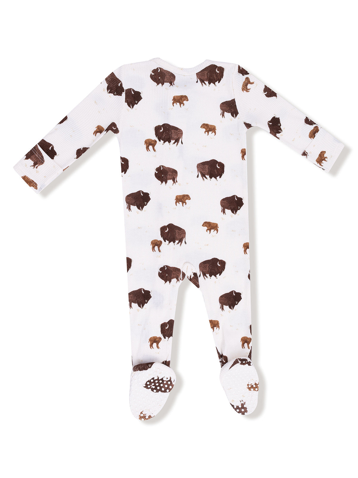 White baby onesie with a bison print and footed design, featuring long sleeves and textured soles.