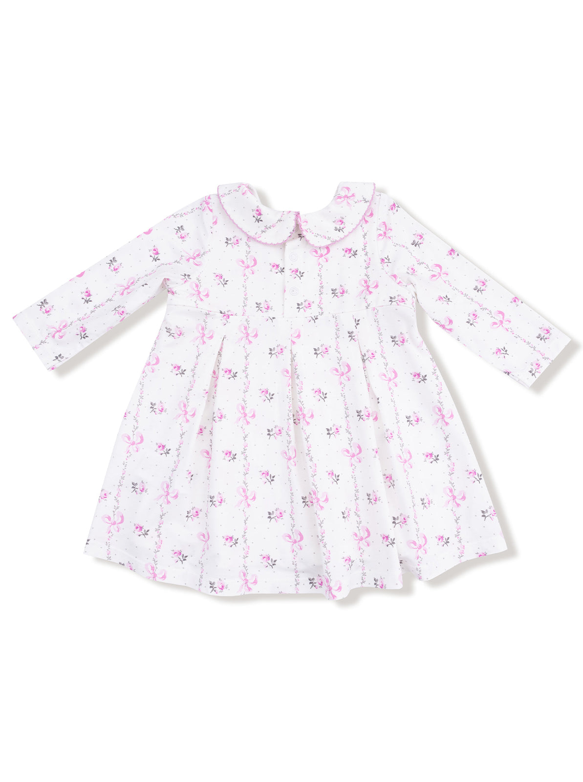 White dress with pink floral and bow print, featuring long sleeves and a rounded collar.