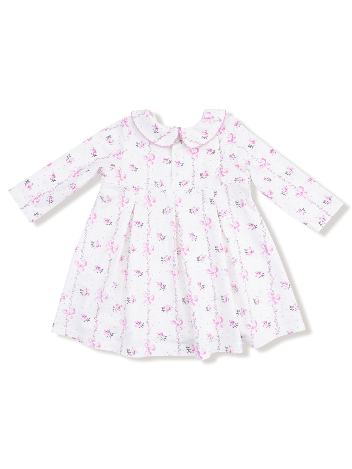 White dress with pink floral and bow print, featuring long sleeves and a rounded collar.