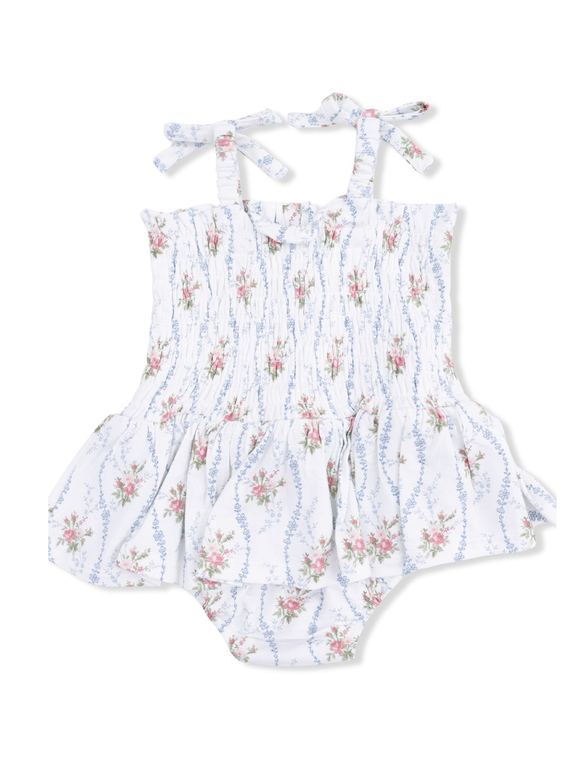 White floral baby romper with smocked bodice and tie straps, featuring a flared skirt and ruffled bottom.