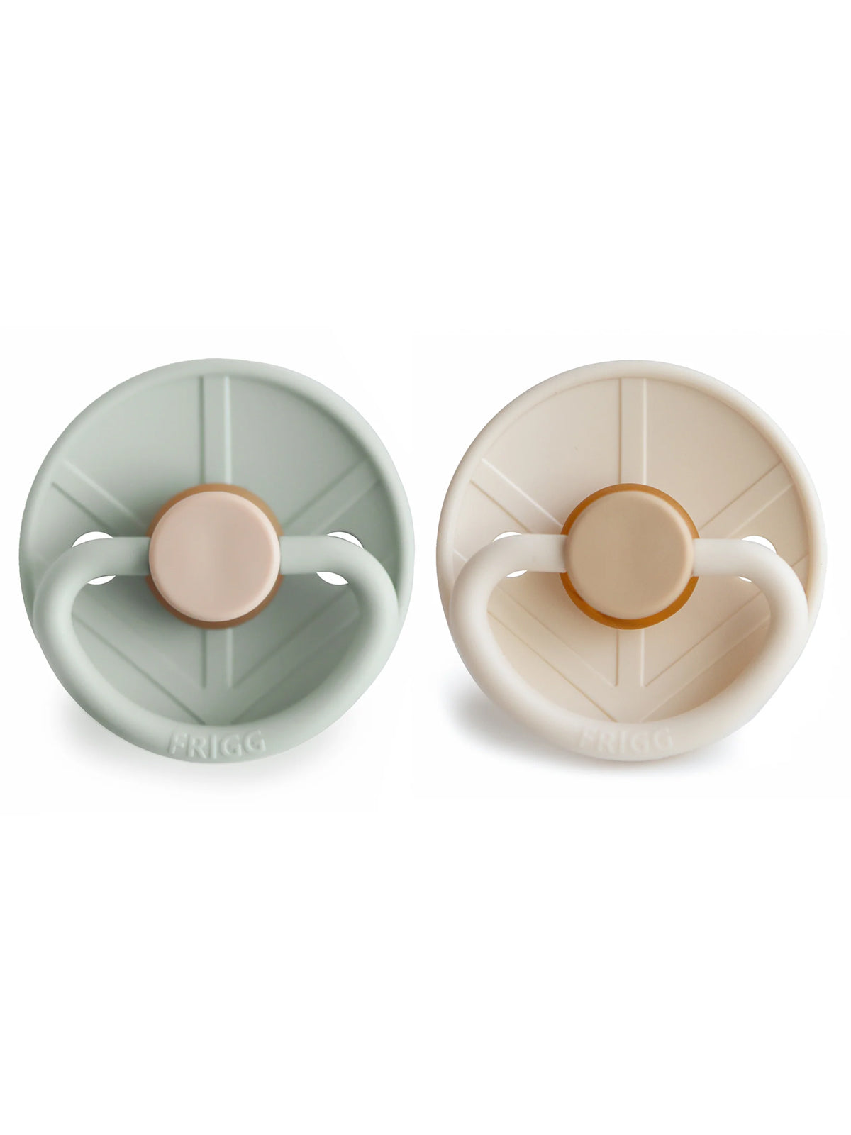 Two baby pacifiers in soft green and cream colors, features a round shield and a soft silicone nipple.