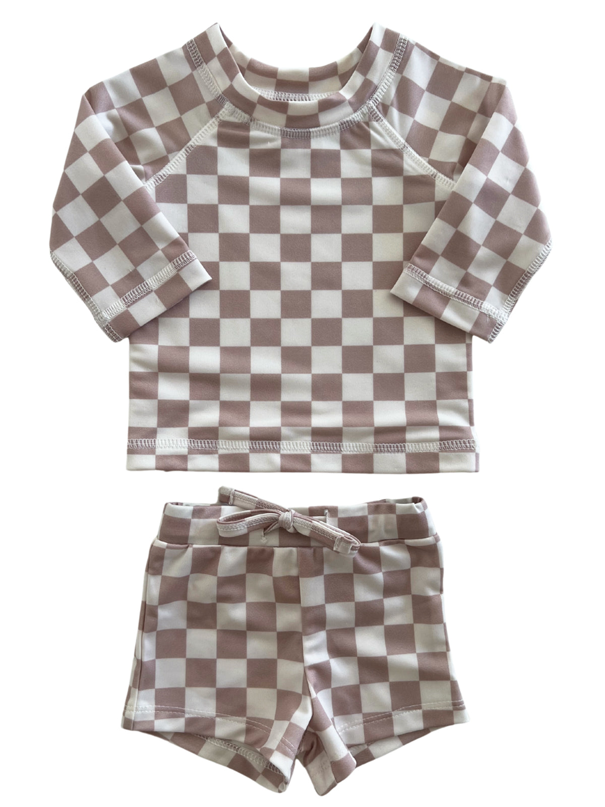 Kids' checkered swim outfit with long sleeves and matching shorts in soft pink and white. Ideal for sunny days.
