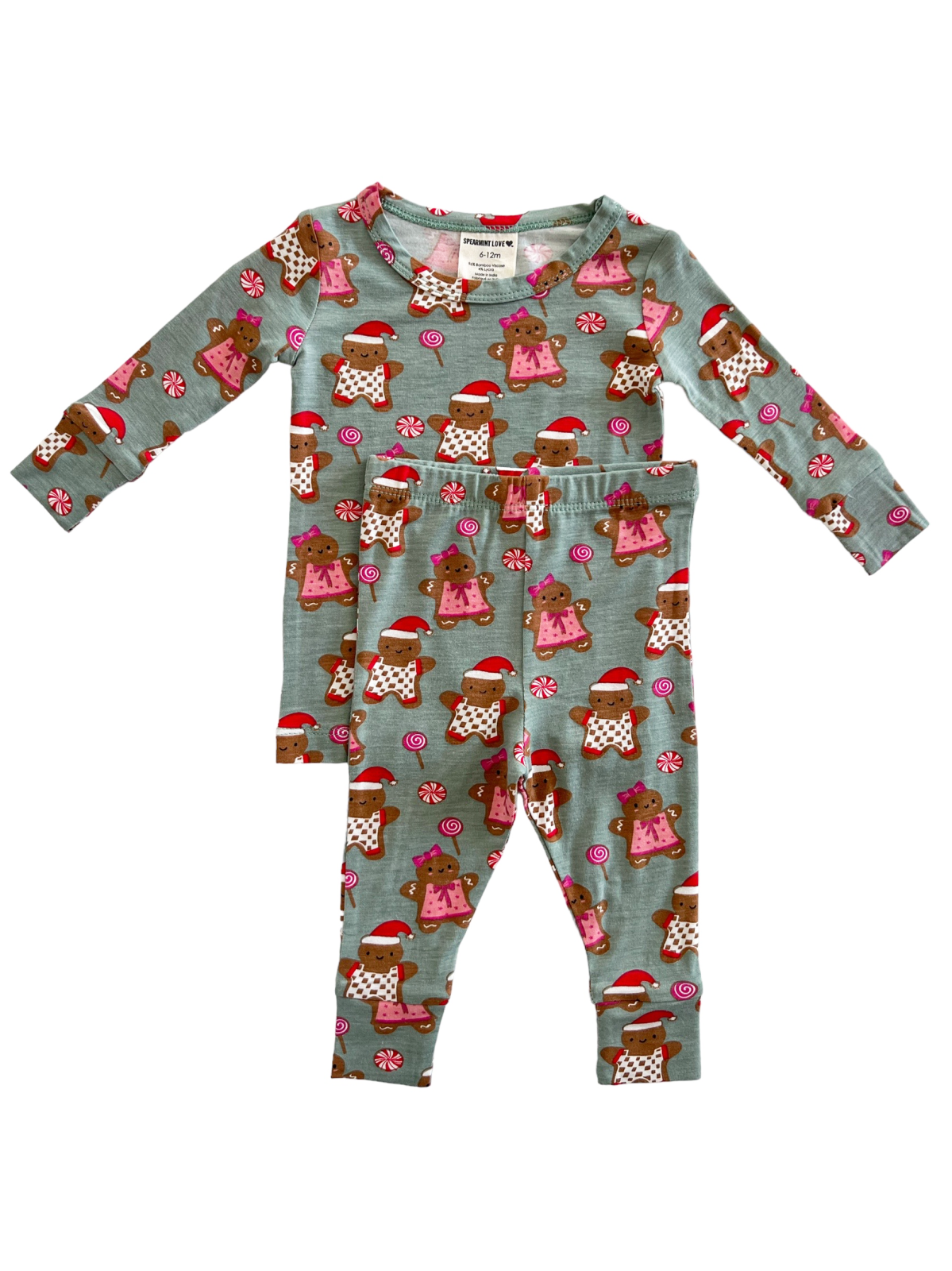 Child's pajama set featuring brown teddy bears in holiday attire on a light blue background.