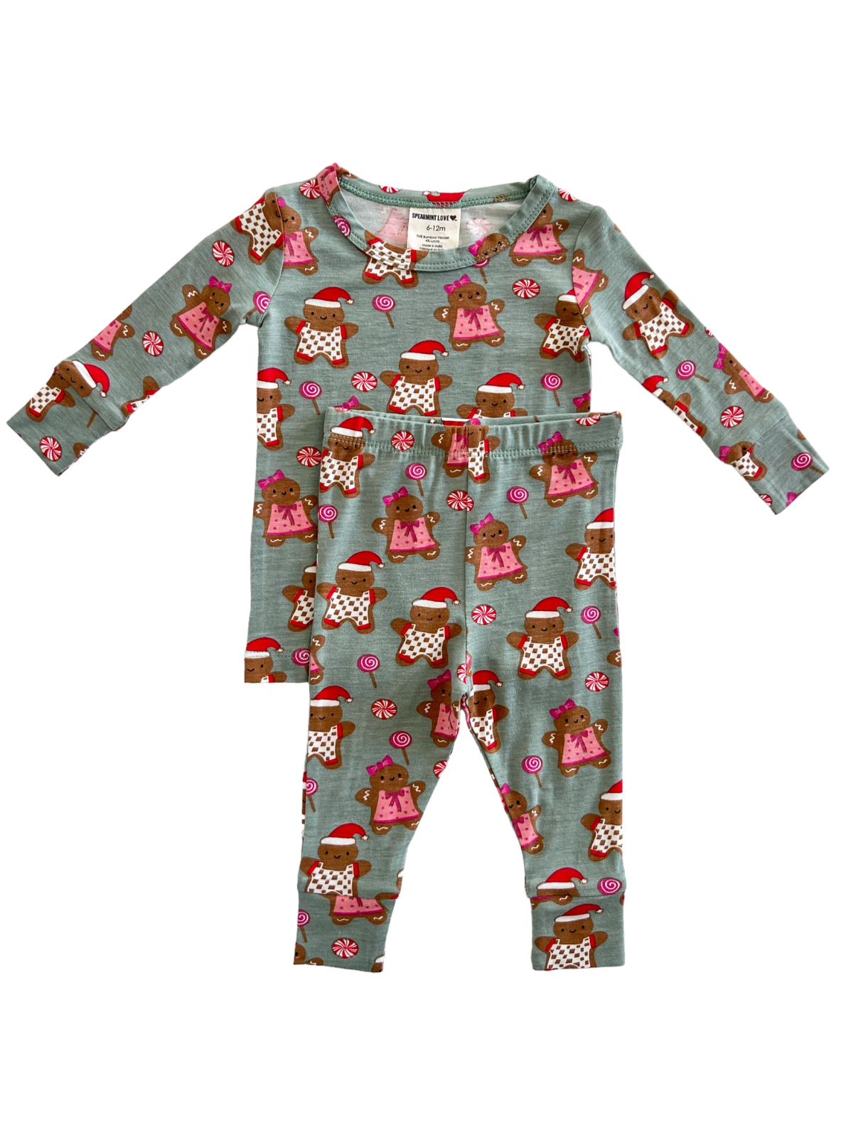 Child's pajama set featuring brown teddy bears in holiday attire on a light blue background.
