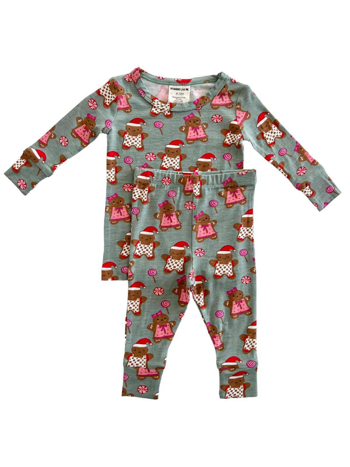 Child's pajama set featuring brown teddy bears in holiday attire on a light blue background.