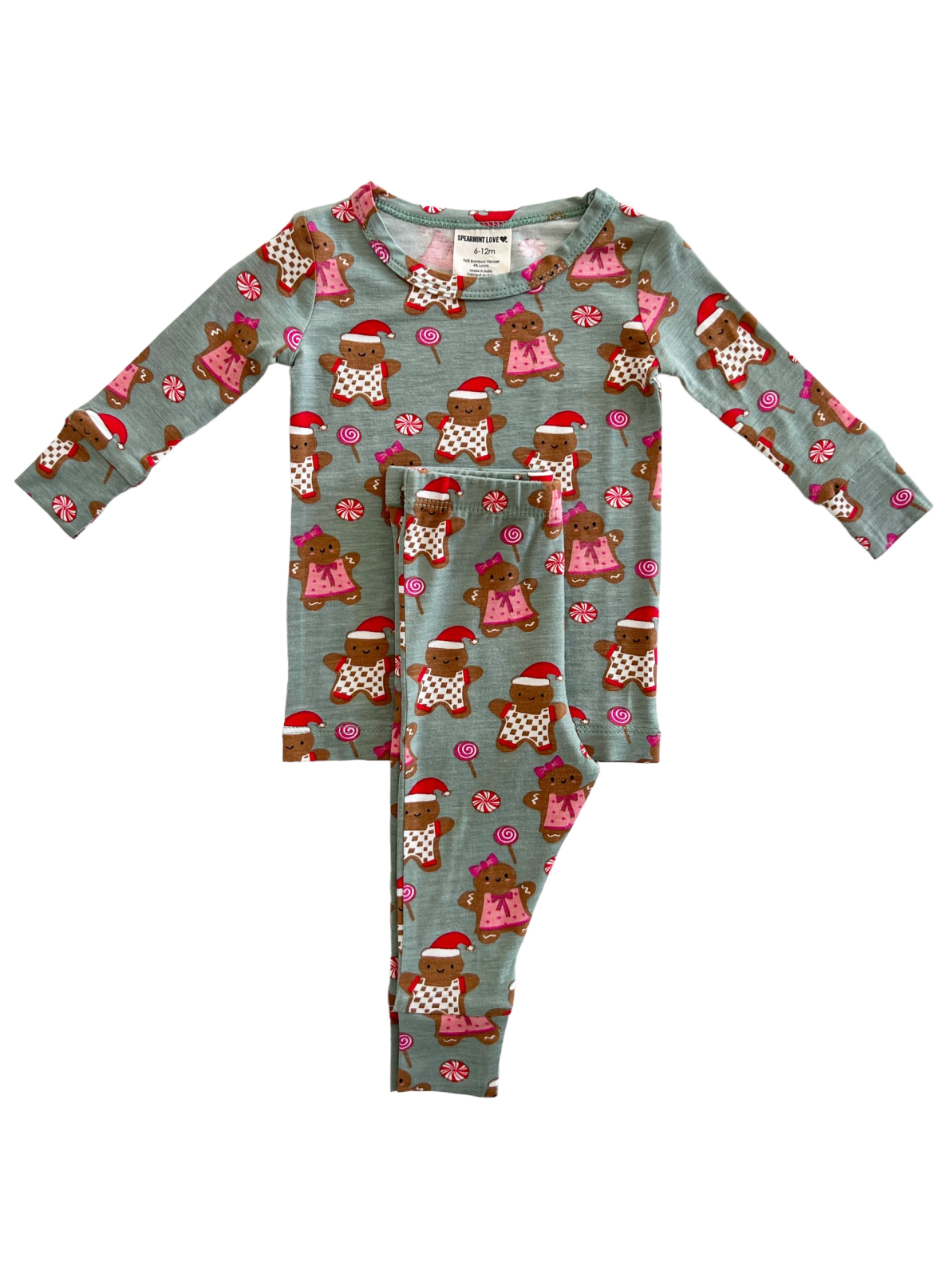 Child's festive pajamas featuring gingerbread designs and candy motifs in light blue. Size 6-12 months.