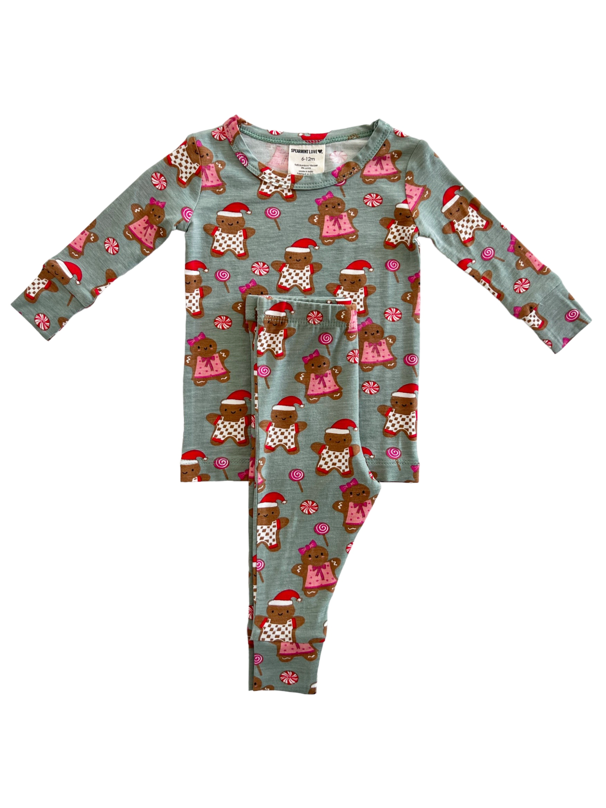Child's festive pajamas featuring gingerbread designs and candy motifs in light blue. Size 6-12 months.