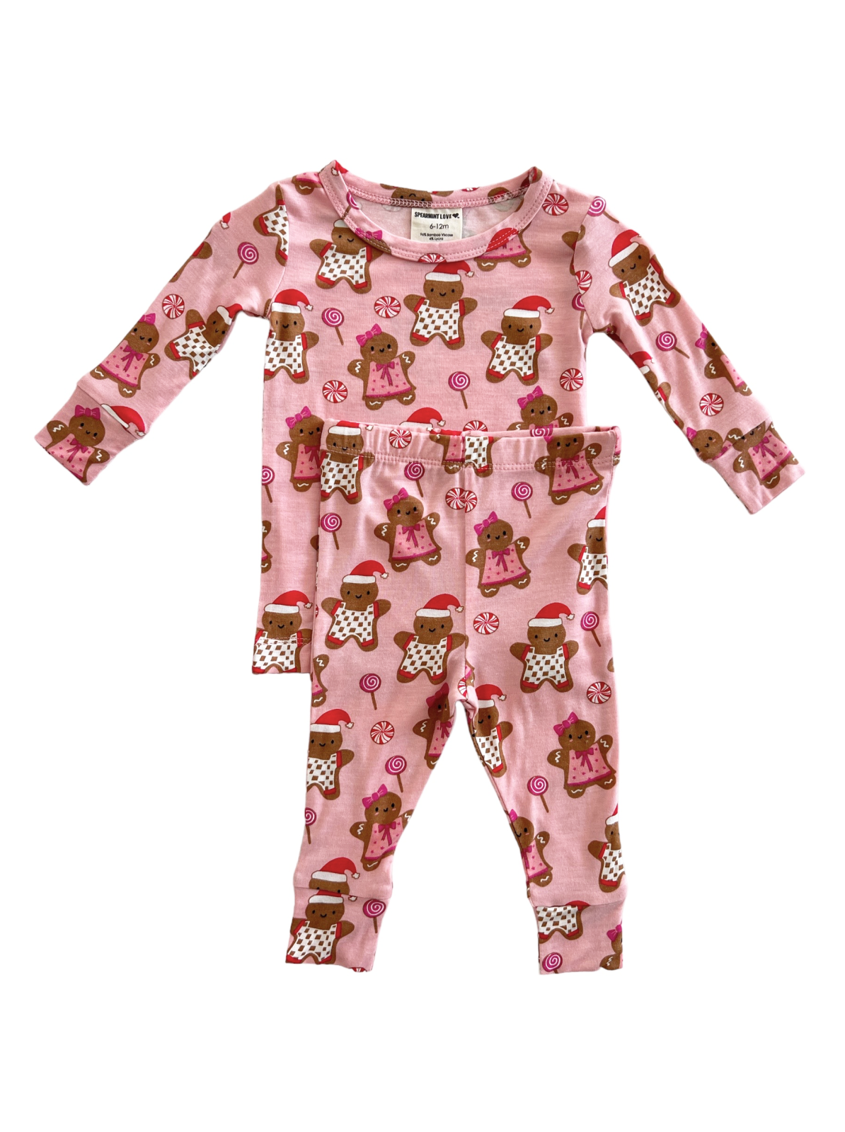 Pink pajama set featuring gingerbread cookies and candy patterns, suitable for infants aged 6-12 months.