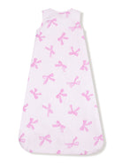 Sleeveless baby sleep sack with a white background and pink bow patterns.