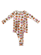 White pajama set featuring colorful pumpkin patterns in orange, pink, and brown hues.