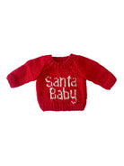 Red knitted sweater with "Santa Baby" text in white, perfect for holiday celebrations and festive outfits.