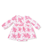 Pink floral dress with long sleeves and a ruffled neckline, positioned on a white background.