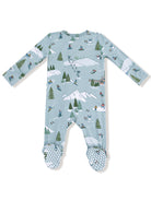 Light blue baby onesie featuring ski scenes, trees, mountains, and snowmen, with polka dot foot grip details.