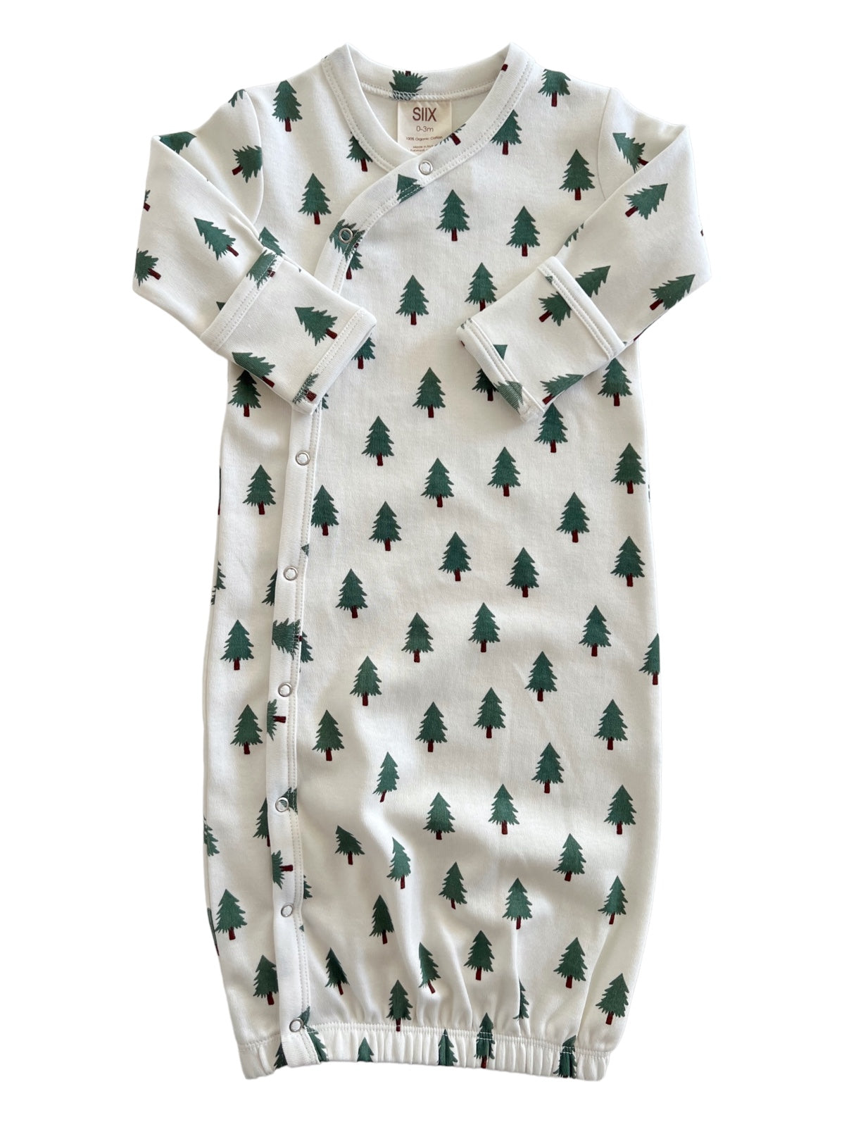 White newborn gown with green tree patterns, featuring snap buttons and elastic at the bottom.