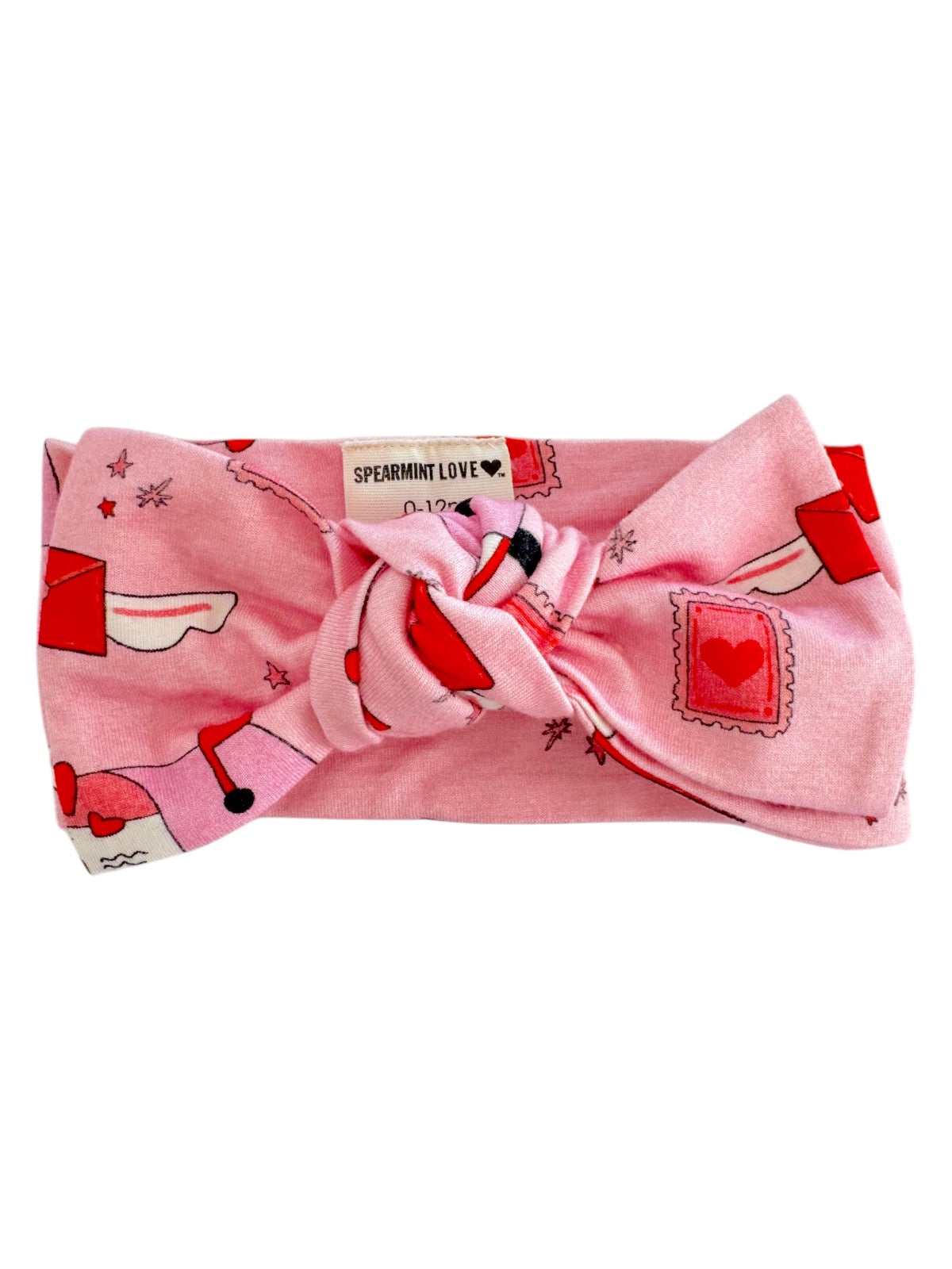 Pink baby headband with knots and playful heart and envelope designs, labeled "Spearmint Love."