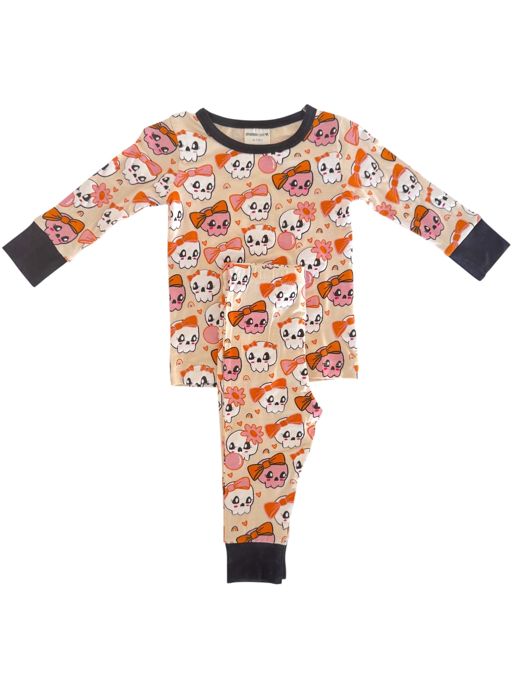 Youth pajamas with playful skull and flower patterns in orange and pink, suitable for casual sleepwear.