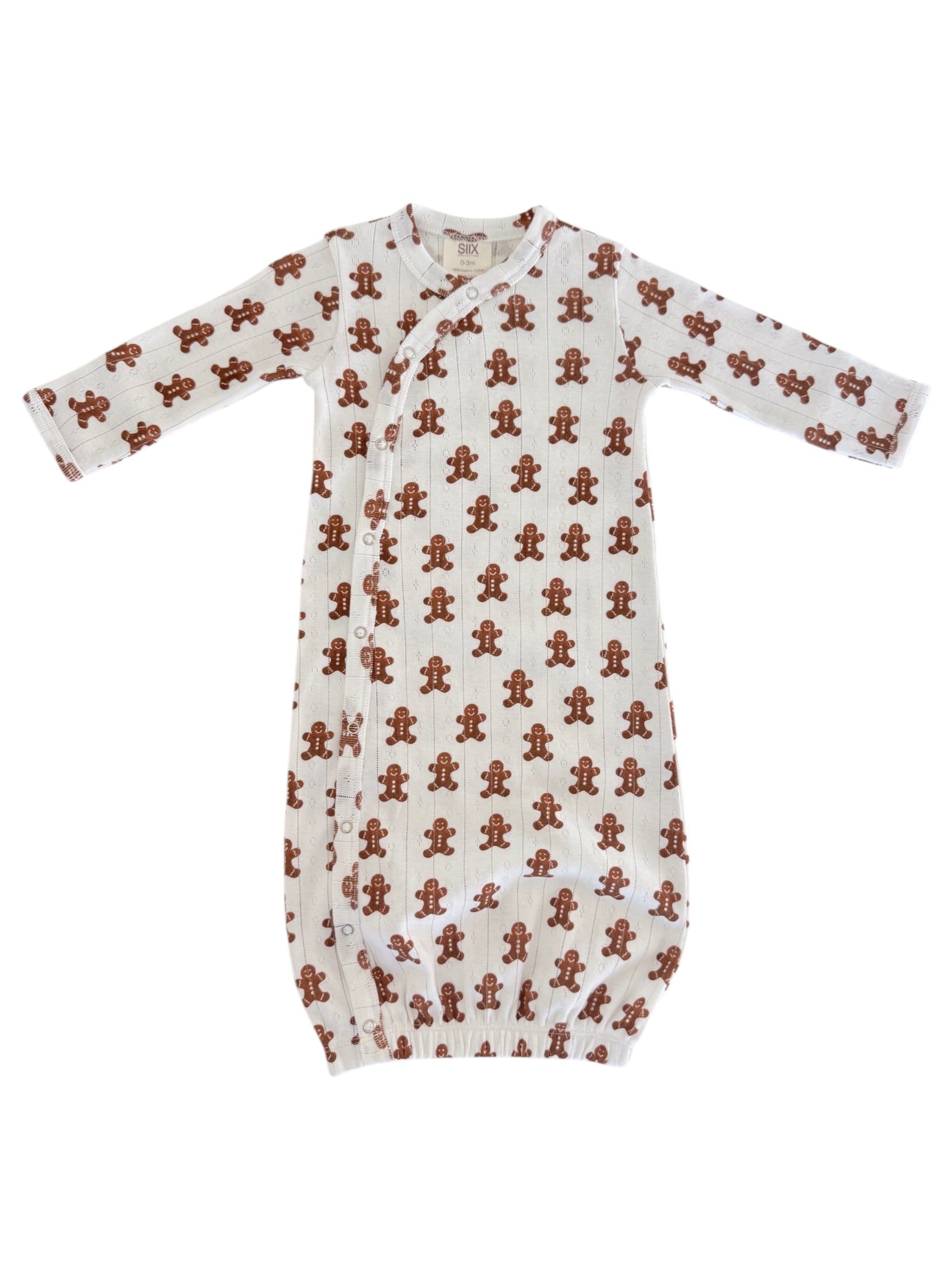 White baby gown with a gingerbread man print, featuring long sleeves and a button closure. Perfect for cozy wear.