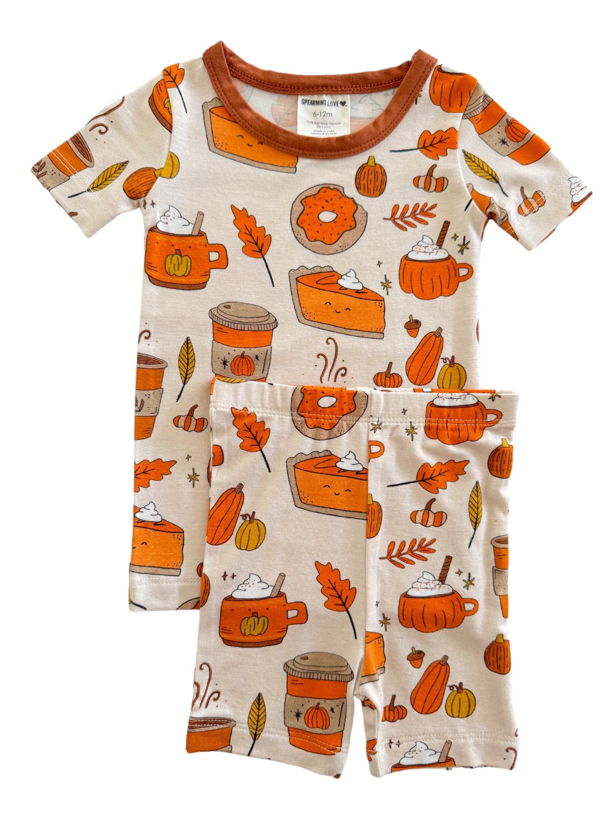 Children's pajamas featuring autumn-themed patterns like pumpkins, leaves, and desserts in warm colors.