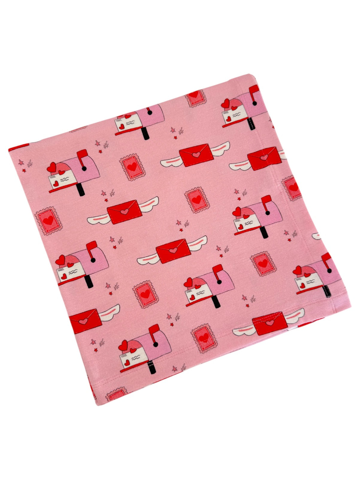 Pink fabric featuring whimsical mailboxes, hearts, and envelopes in a playful design.