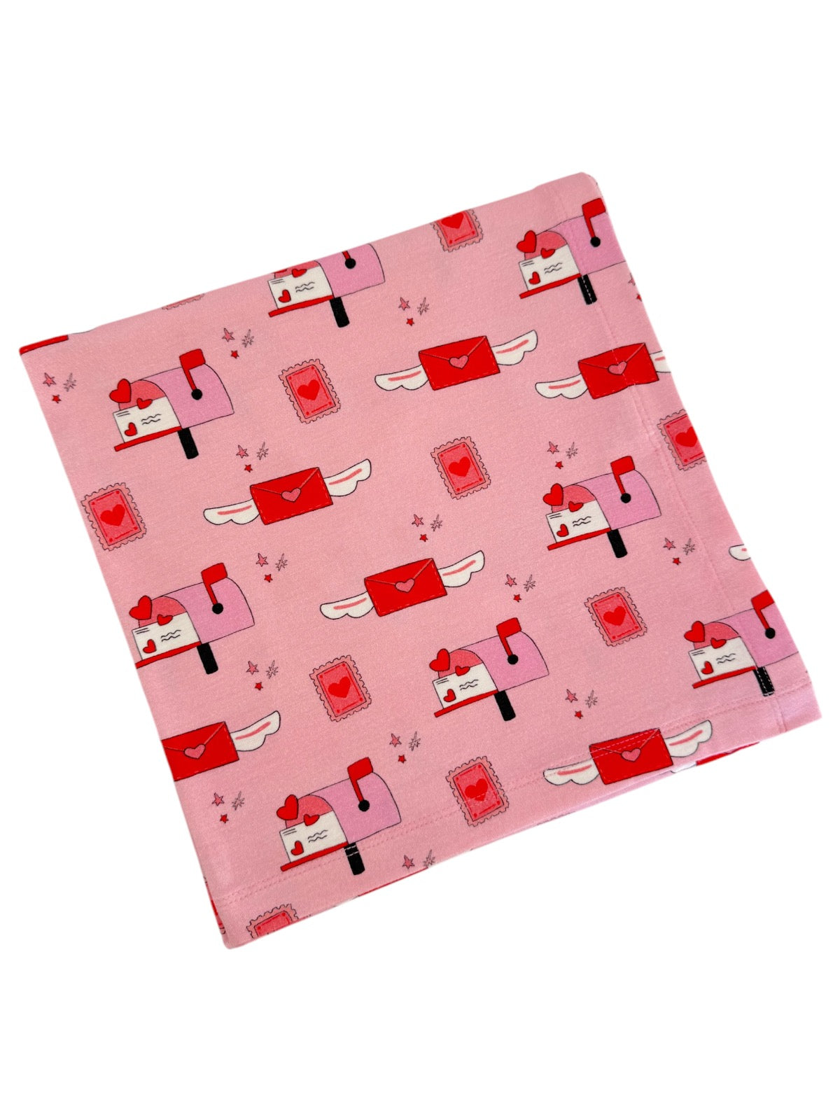 Pink fabric featuring whimsical mailboxes, hearts, and envelopes in a playful design.