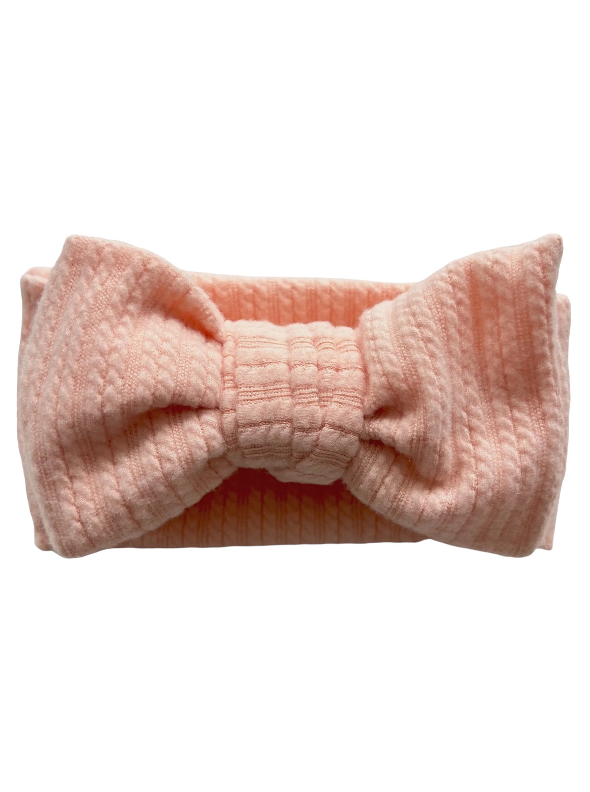 Pink textured headband with a large bow, designed for style and comfort.