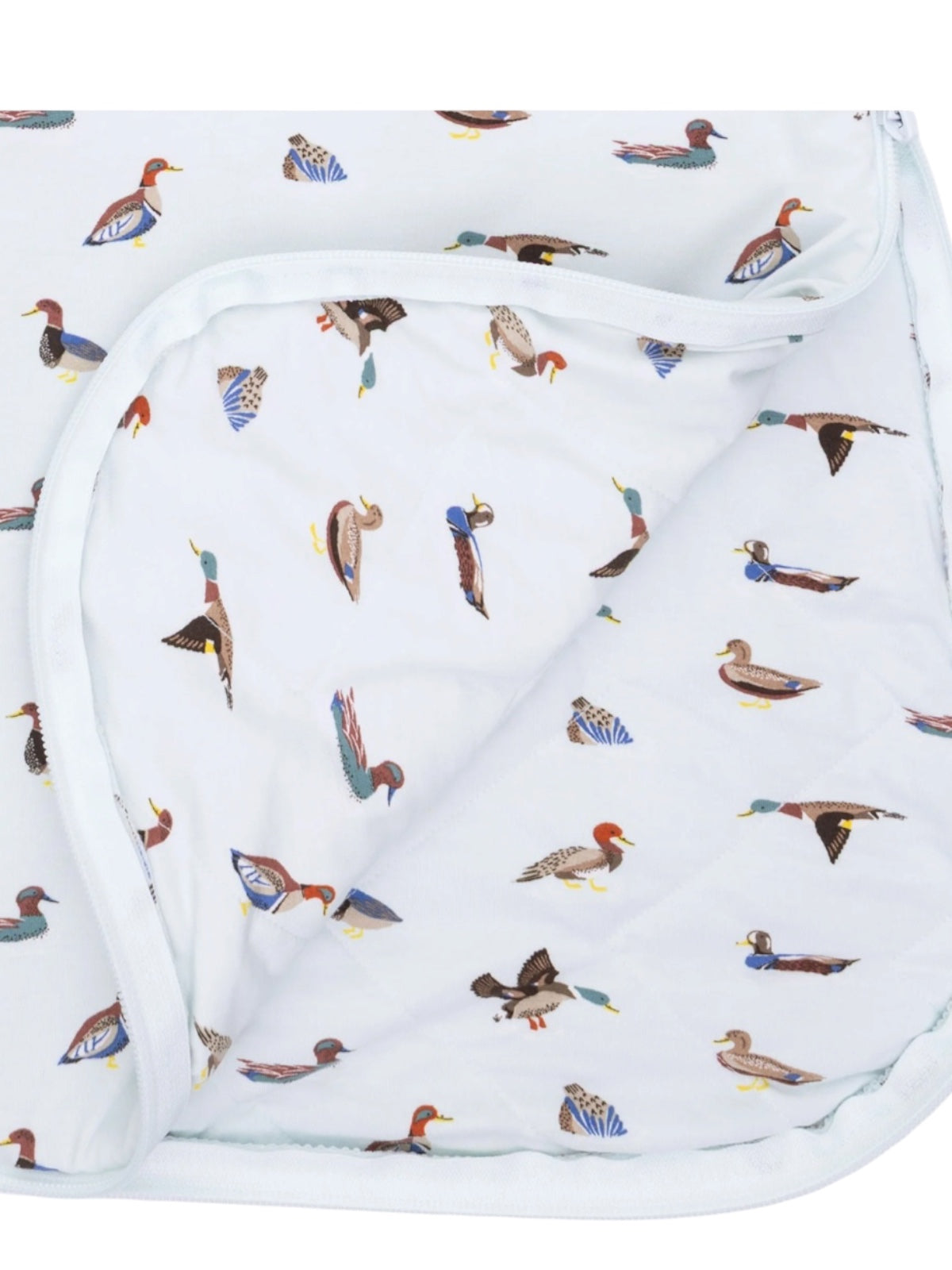 Patterned blanket featuring various illustrated ducks on a light background.
