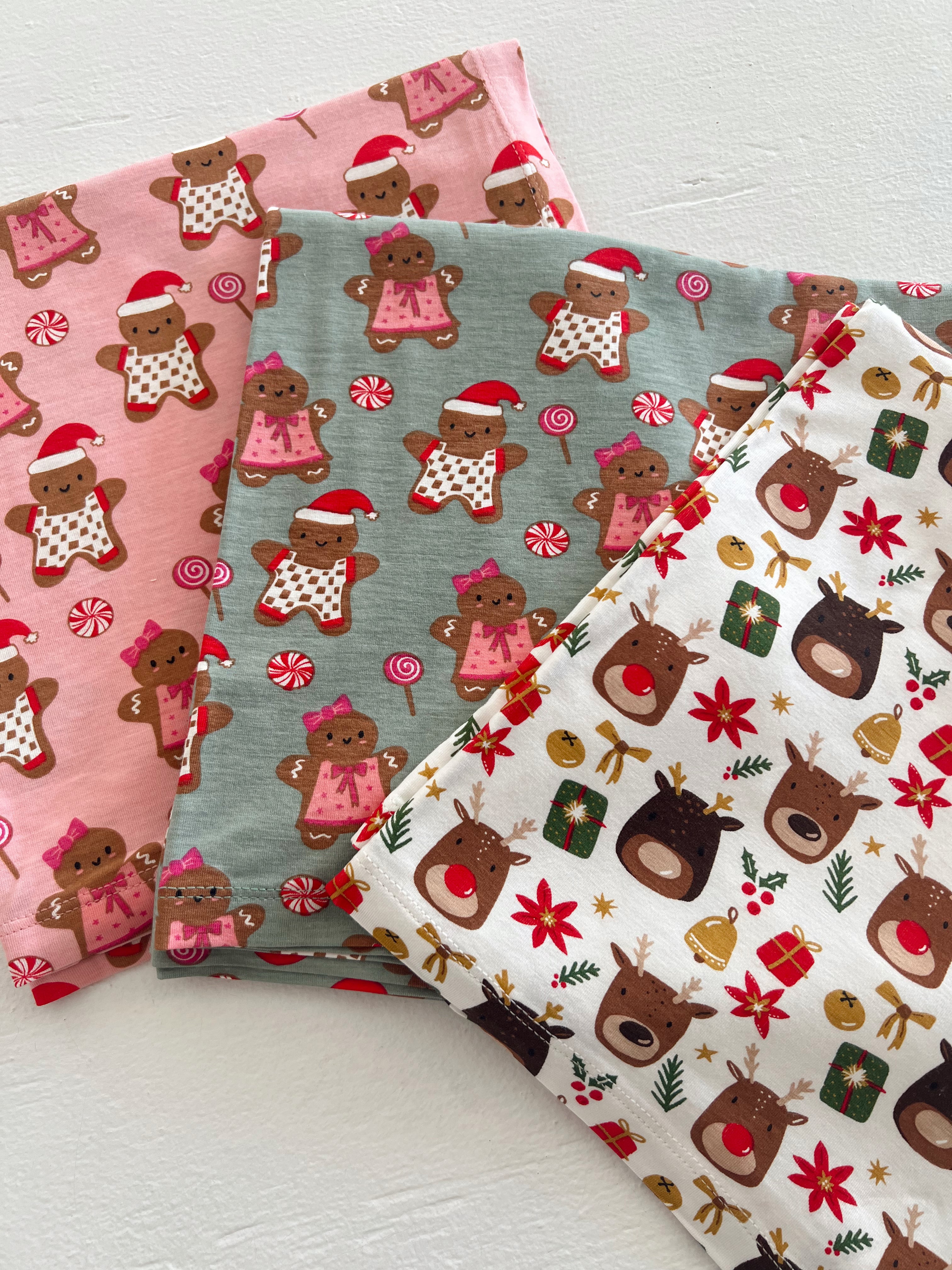 Three festive fabric swatches featuring gingerbread characters and reindeer in Christmas-themed patterns.