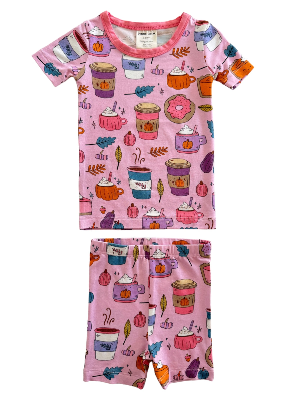 Pink kids' pajama set featuring colorful drinks and autumn-themed patterns. Ideal for cozy sleepwear.