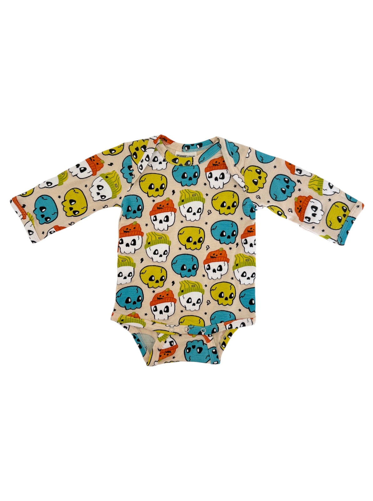 Long-sleeve baby onesie with colorful skull pattern on a light background.