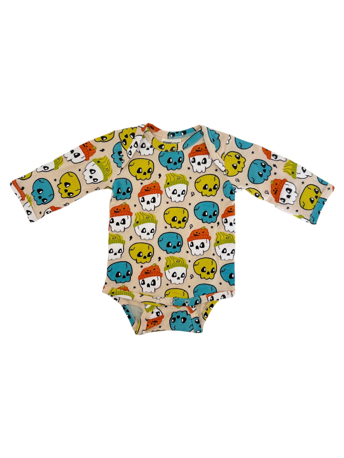 Long-sleeve baby onesie with colorful skull pattern on a light background.