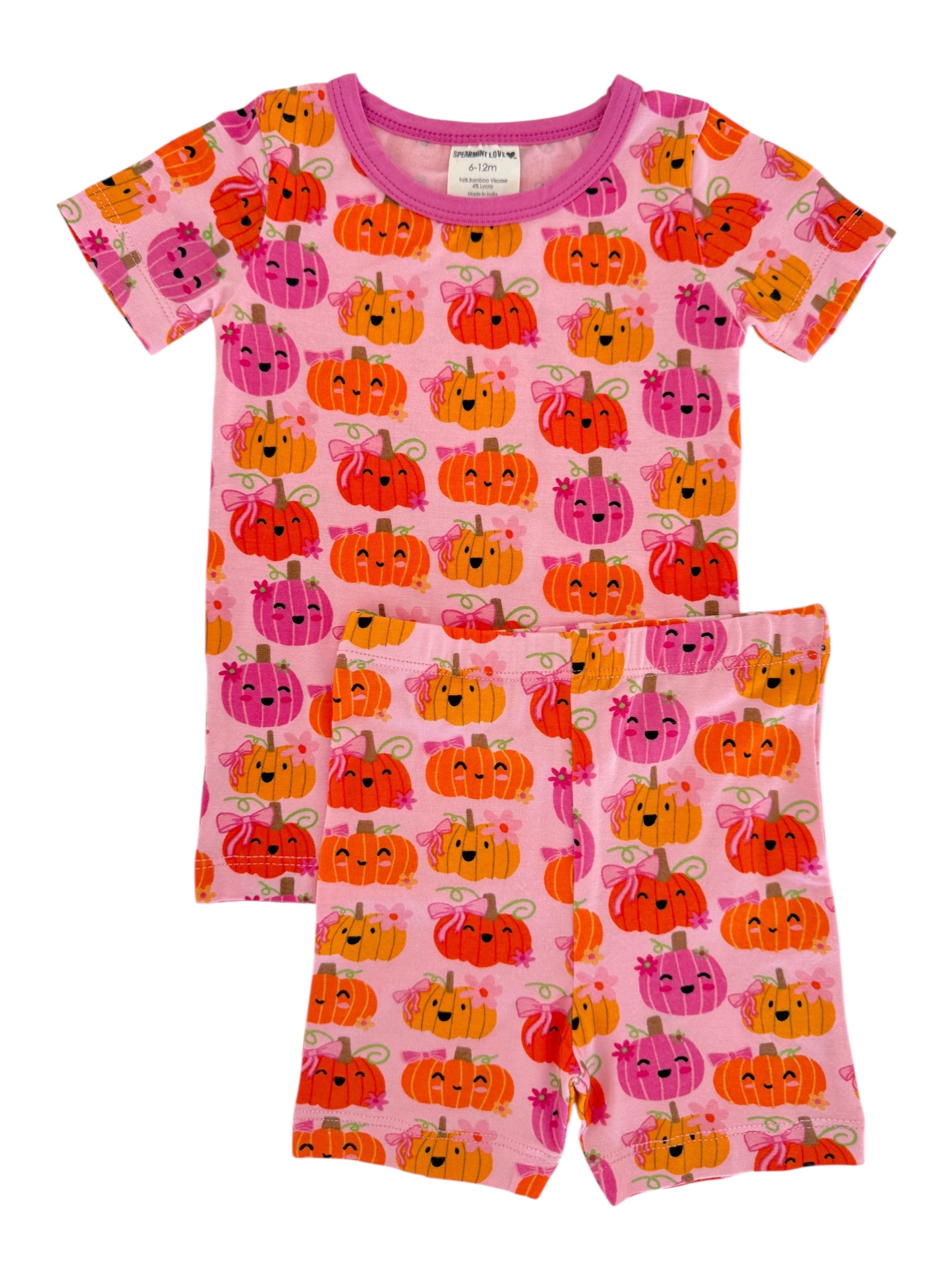 Pink pajama set featuring colorful, smiling pumpkins with bows, suitable for infants and toddlers.