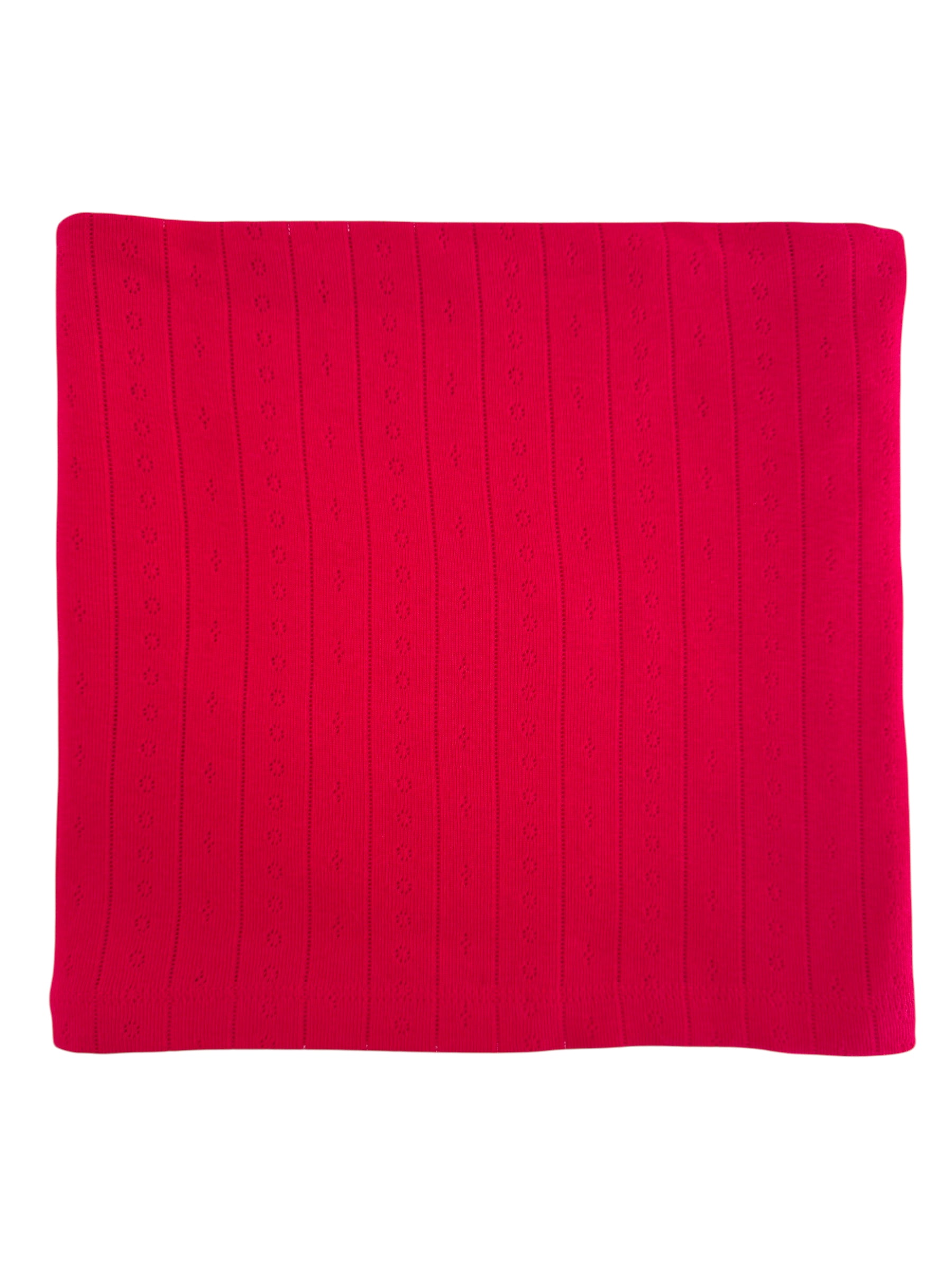 Red knitted blanket with a textured pattern of vertical lines and small flowers.