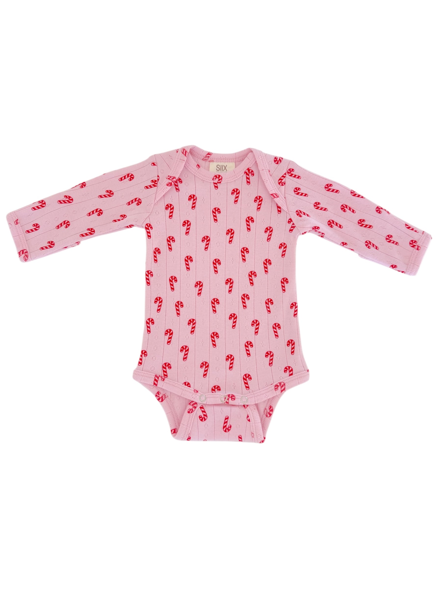 Light pink long-sleeve baby onesie with red candy cane print. Ideal for festive occasions.