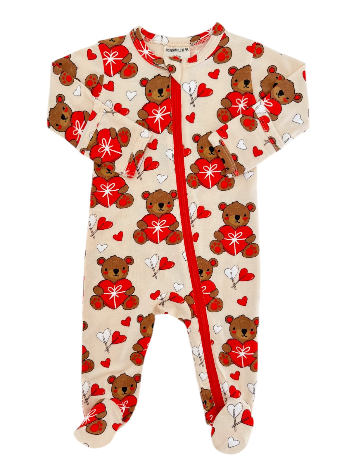 "Tan toddler onesie with bear and heart pattern, featuring a front zipper and long sleeves."