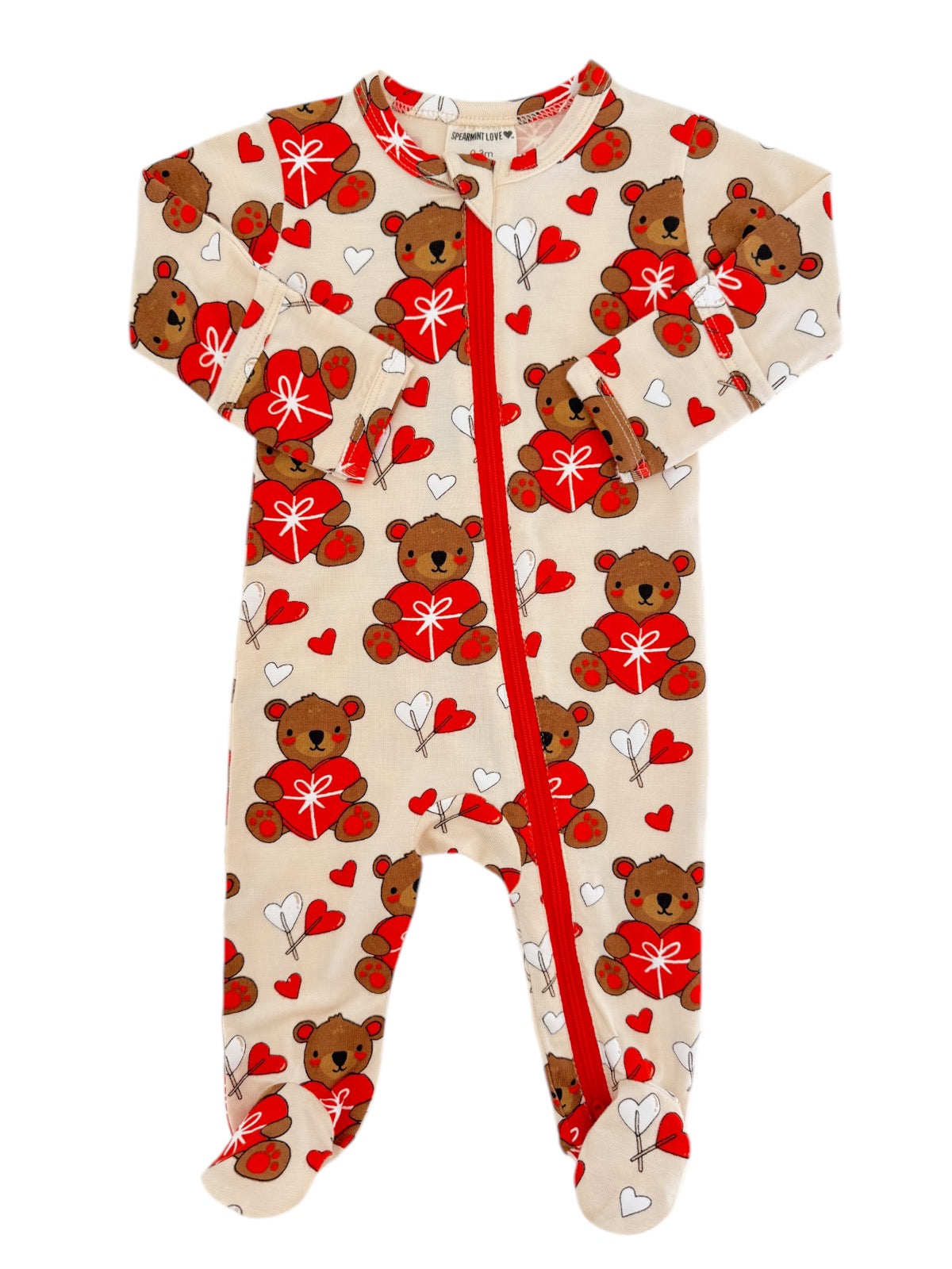 "Tan toddler onesie with bear and heart pattern, featuring a front zipper and long sleeves."