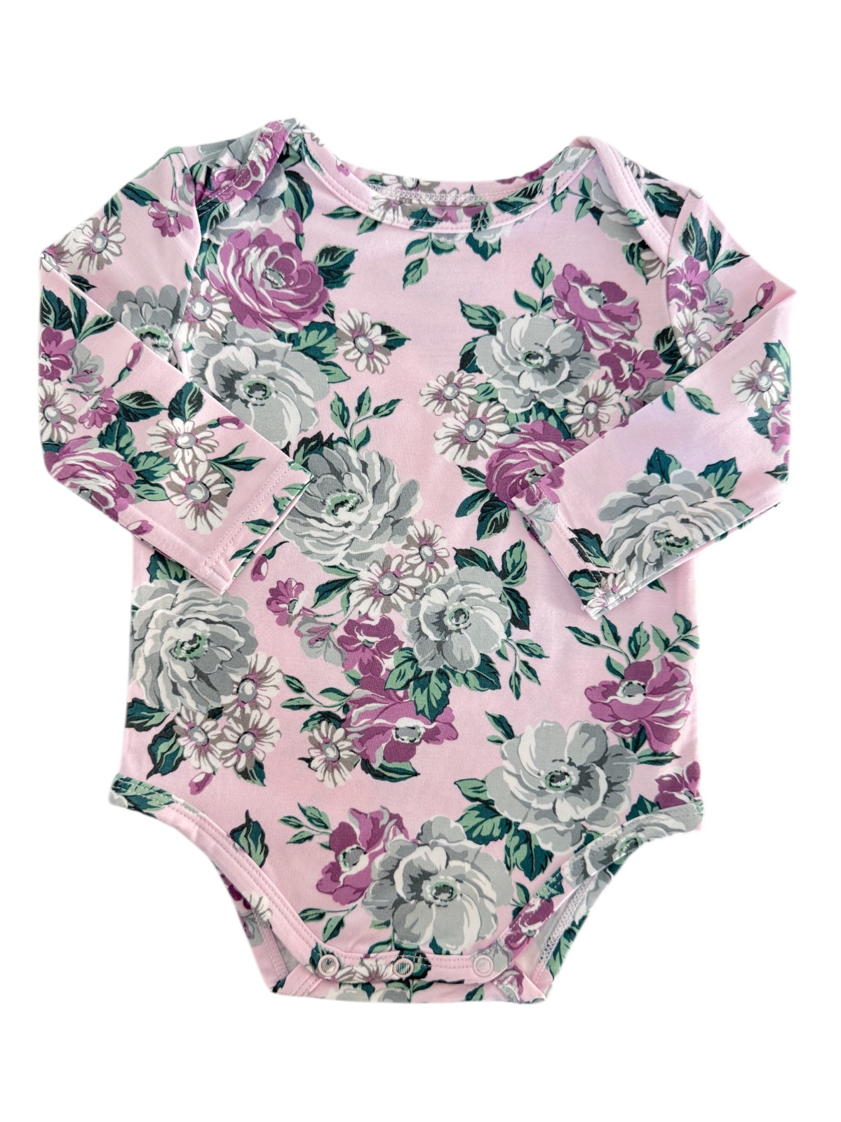 Pink floral long-sleeve baby bodysuit with purple and gray roses and green leaves on a creamy background.