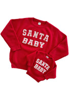 Red "Santa Baby" sweaters for adults and children, featuring textured white lettering. Perfect for festive family photos.