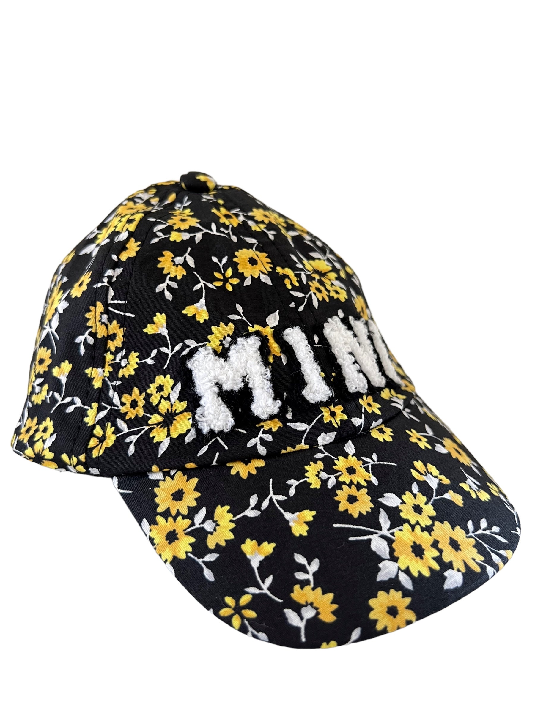 Floral black cap with yellow flowers and white "MINE" text embroidered on the front.